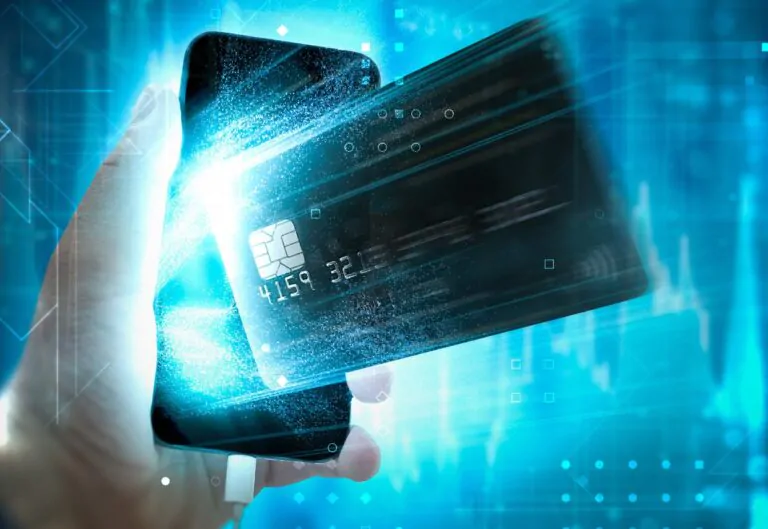 Credit card coming out of a smartphone in front of a futuristic blue background