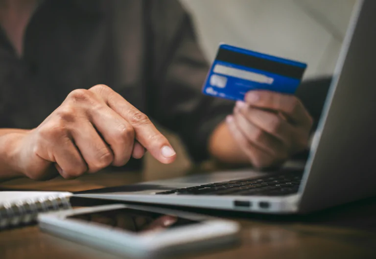 Person entering credit card details into their laptop