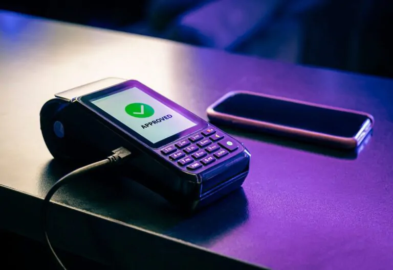 Purple lights illuminate a payment gateway and a smartphone