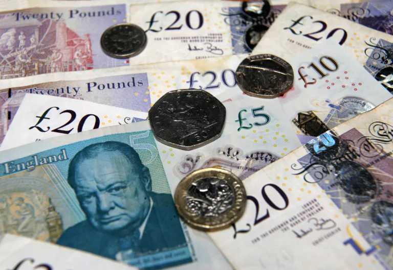 British pounds, coins and notes, lying together on a table