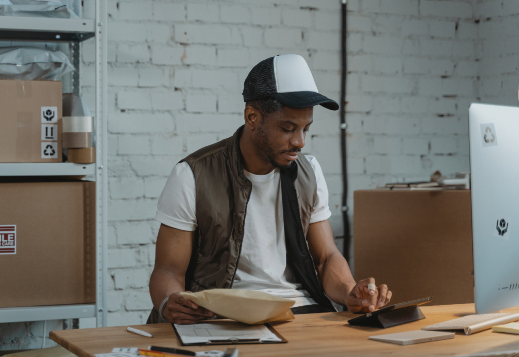 Merchant sitting at computer